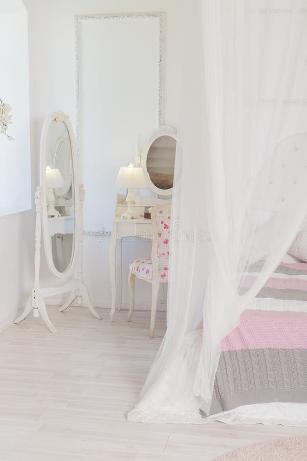 Bright, clean stylish interior bedroom with a large panoramic window. beautiful rich antique furniture. four-poster bed royalty free stock images Bright, clean stylish interior bedroom with a large panoramic window. beautiful rich antique furniture. four-poster bed royalty free stock images
