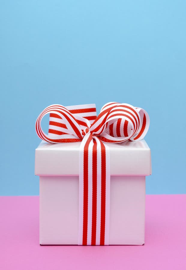 Bright Color Gift Box on Pink and Blue Background. Stock Photo Image