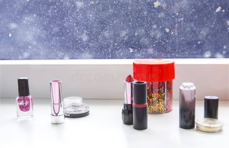 Bright composition of fashion accessories. Lipsticks, nail polish and tinsel. Objects on soft pastel background. Flat lay, top stock photo Bright composition of fashion accessories. Lipsticks, nail polish and tinsel. Objects on soft pastel background. Flat lay, top stock photo