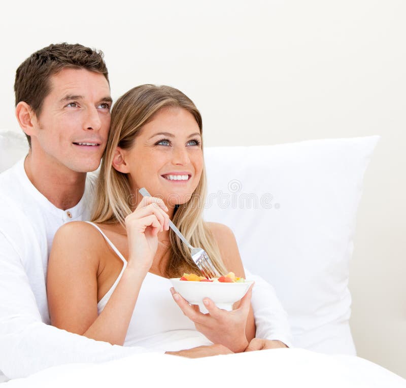 Bright couple having breakfast royalty free stock photography