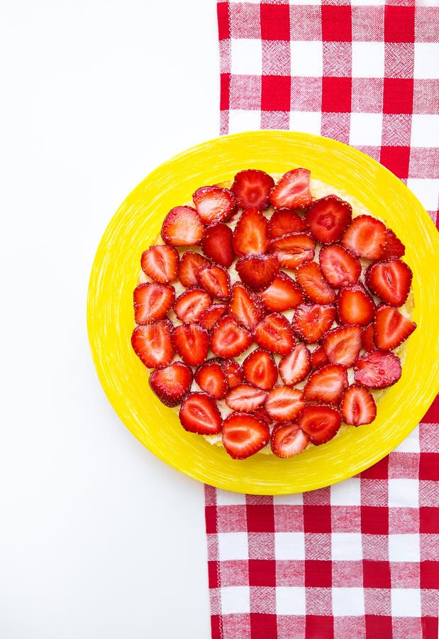 Bright and delicious strawberry cake on a red napkin in a cage stock photo Bright and delicious strawberry cake on a red napkin in a cage stock photo