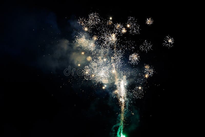 Bright fireworks burst in a dark night sky, creating a dazzling display of light and color. royalty free stock photo