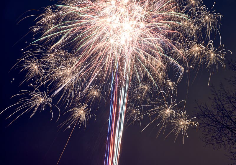 Bright fireworks explode in the night sky, creating a colorful and dazzling display of light and sparks royalty free stock photos