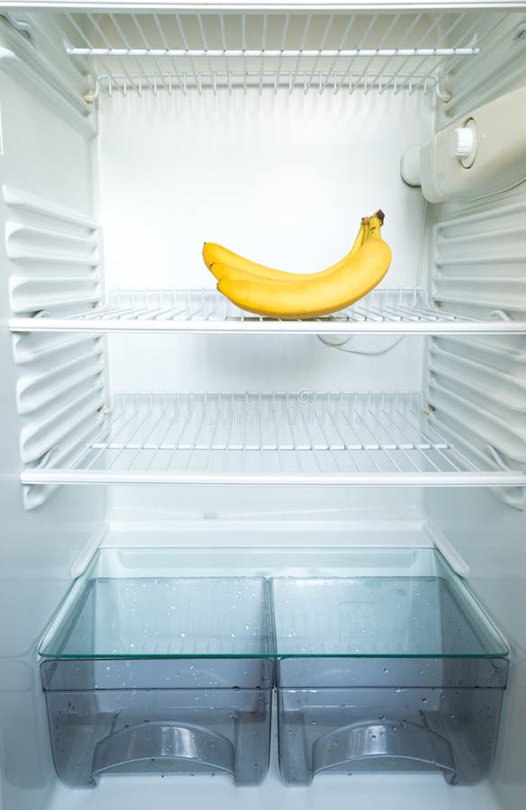 Bright Fresh Banana Glowing In The Dark On Shelf Of Open Empty