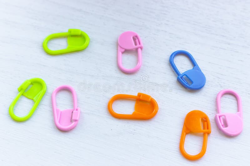 Bright knitting markers on white background. Colourful knitting pins. Knitting tools. Needlework accessories concept. stock image