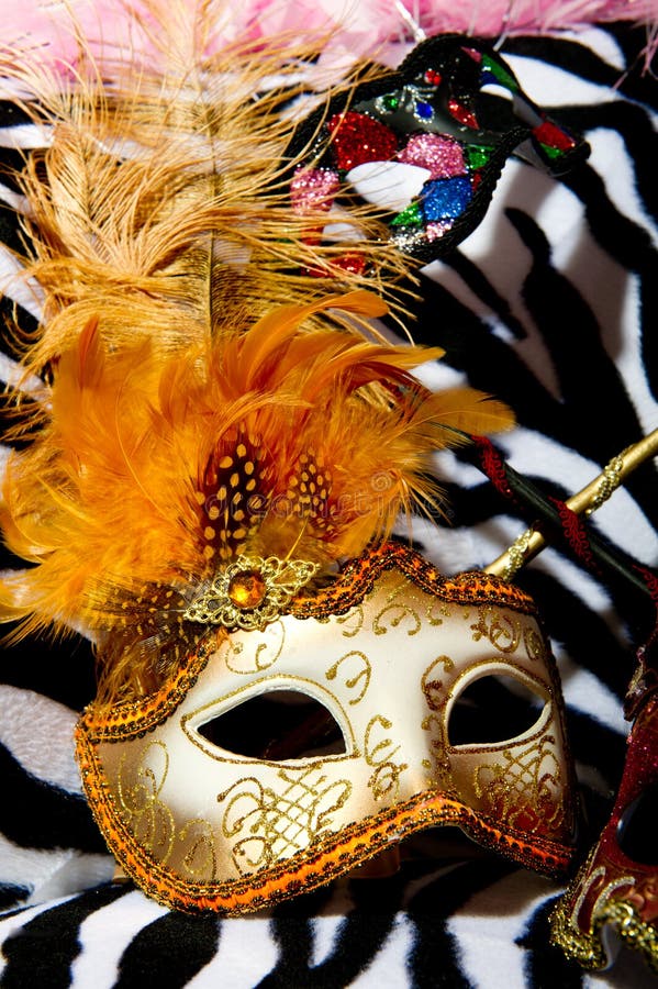 Bright masquerade masks on retro chair. Image shoeing brightly coloured masquerade masks on retro style chair royalty free stock photos Bright masquerade masks on retro chair. Image shoeing brightly coloured masquerade masks on retro style chair royalty free stock photos