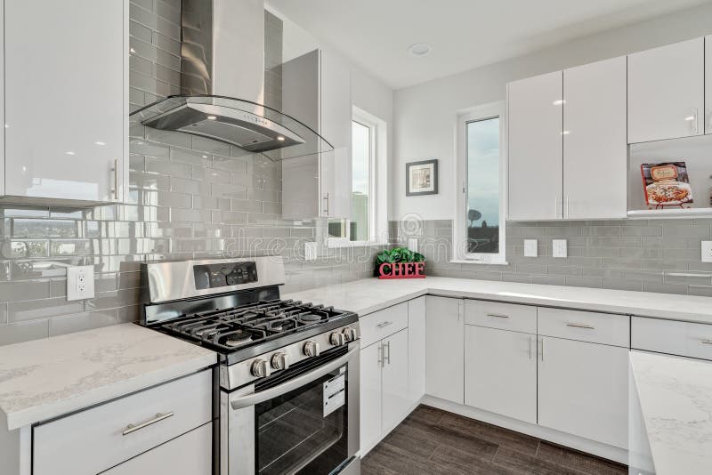 Bright and neutral kitchen with glossy gray subway tile backsplash