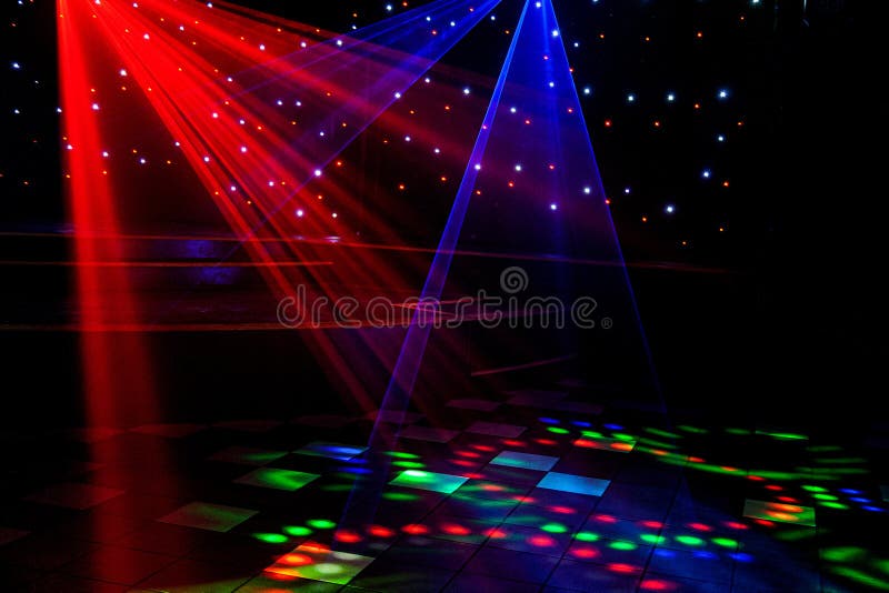 Bright nightclub red, green, purple, white, pink, blue laser lights cutting through smoke machine smoke making light and rainbow