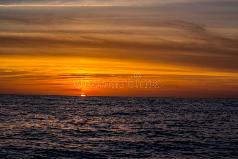 Bright orange sunset on the Atlantic off the Florida coast