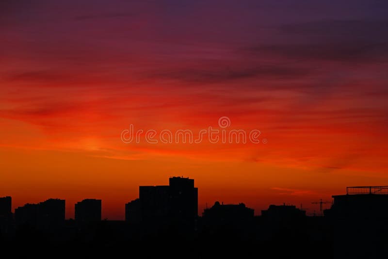 Bright Orange Sunset Over the City in the Evening. Bright Lights of ...