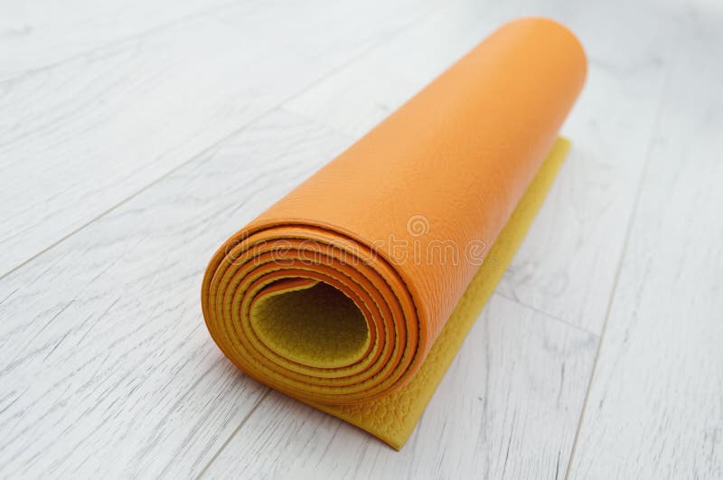 Bright Orange Yoga Mat on a Light Gray Laminate Stock Photo Image of