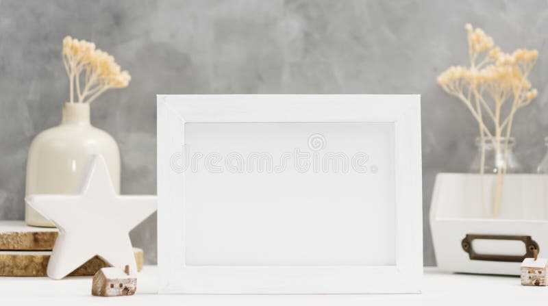 Bright Photo frame mock up with plants in vase, ceramic decor on shelf against grey wall. Scandinavian style royalty free stock image