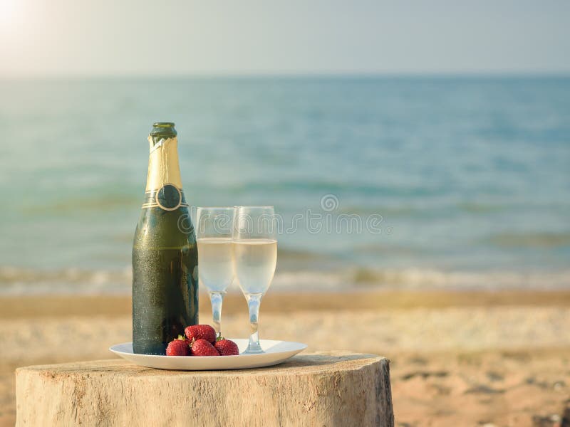 Bright Rays Of The Sun Illuminate The Bottle Of Champagne On The Beach Stock Image Image Of