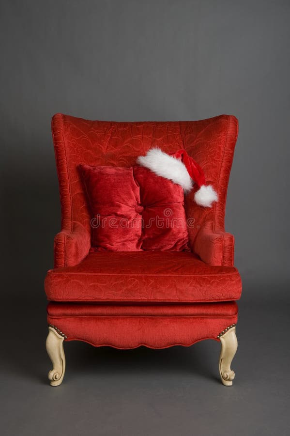 Bright Red Chair with Santa Hat Stock Image - Image of design, comfort