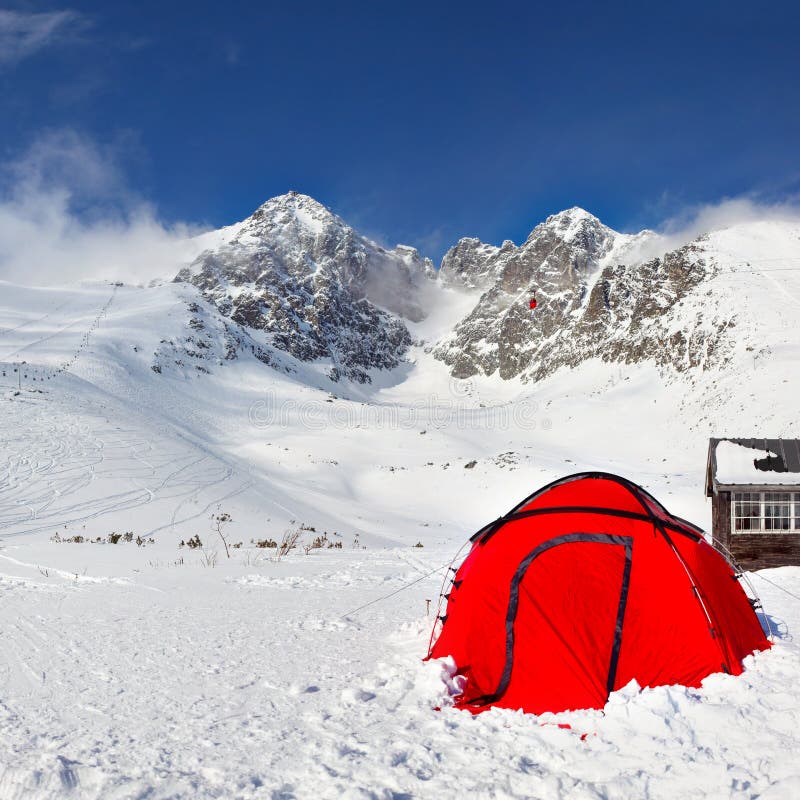 Bright red climbing tent on snow