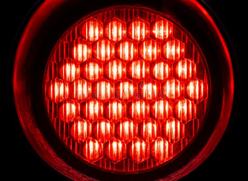 Bright round red light in the dark, object macro, detail, closeup, circle shape, nobody. Red alert, emergency alarm, warning royalty free stock photography