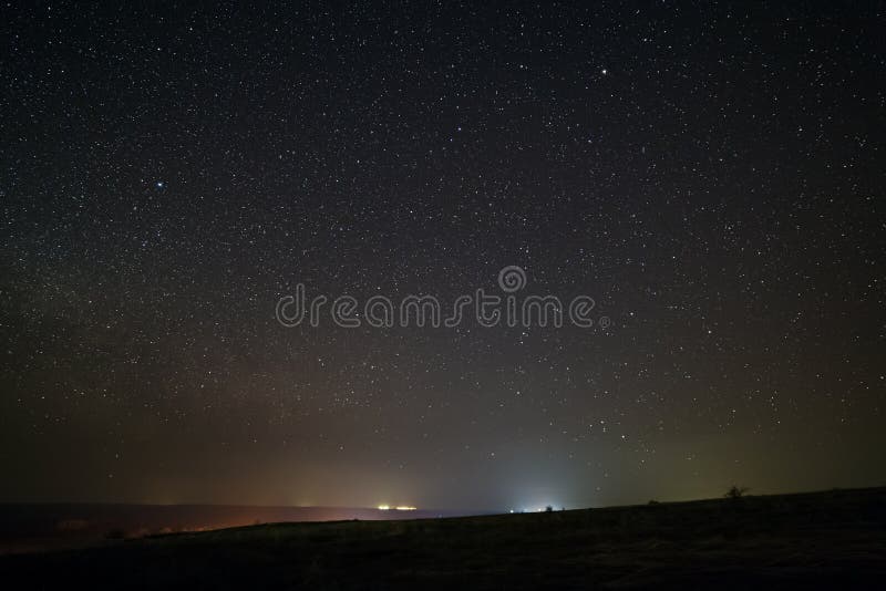Bright stars in the night sky with lighting from the street lamps of the city. Light pollution royalty free stock photography Bright stars in the night sky with lighting from the street lamps of the city. Light pollution royalty free stock photography