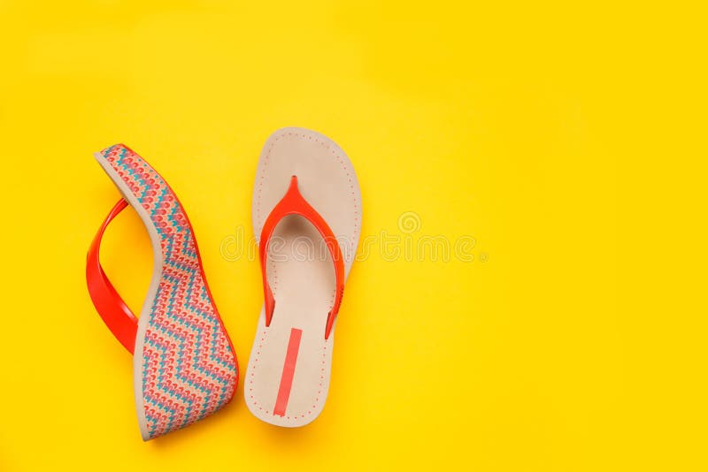 Bright summer women`s sandal isolated on yellow background. Top view