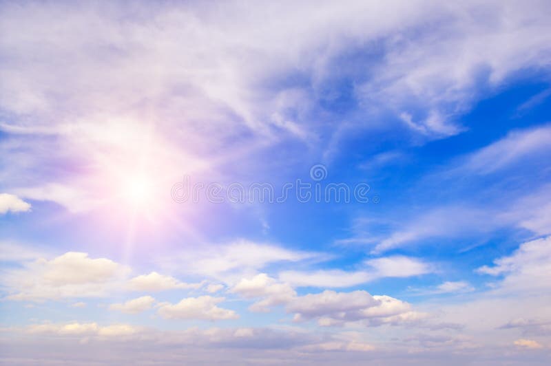 Sun on blue sky with white clouds. royalty free stock photo