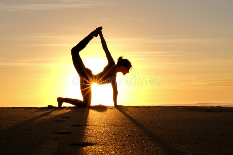 Bright sunrays behind yogi master forming silhouette stock photography