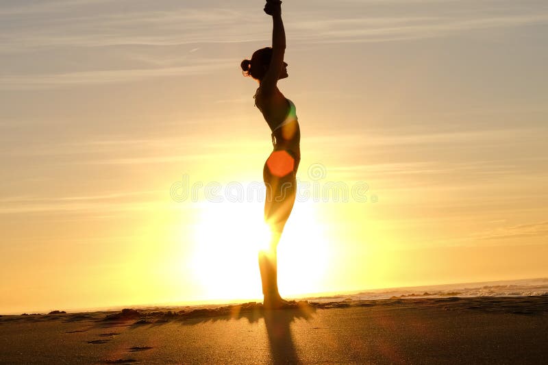 Bright sunrays behind yogi master forming silhouette stock photos
