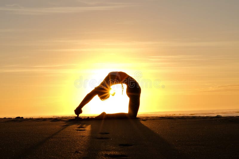 Bright sunrays behind yogi master forming silhouette royalty free stock images