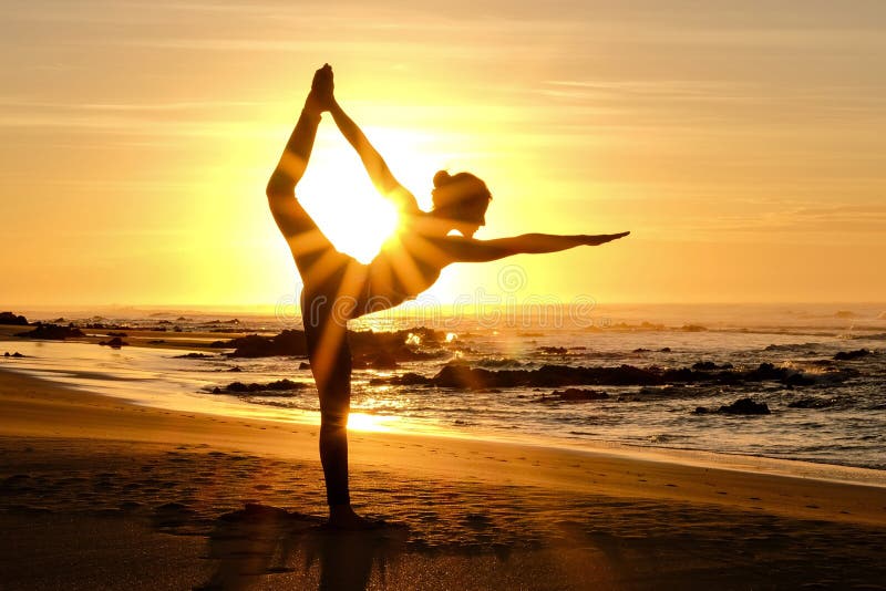 Bright sunrays behind yogi master forming silhouette stock images