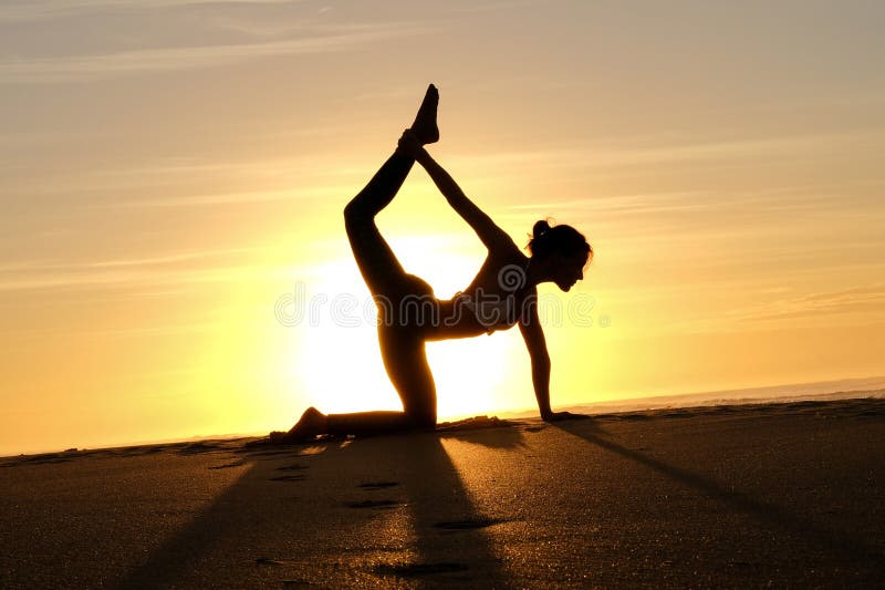 Bright sunrays behind yogi master forming silhouette stock images