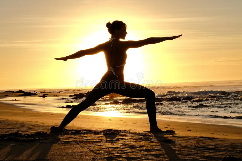 Bright sunrays behind yogi master forming silhouette royalty free stock image