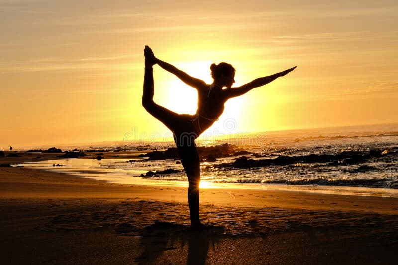 Bright sunrays behind yogi master forming silhouette stock photography