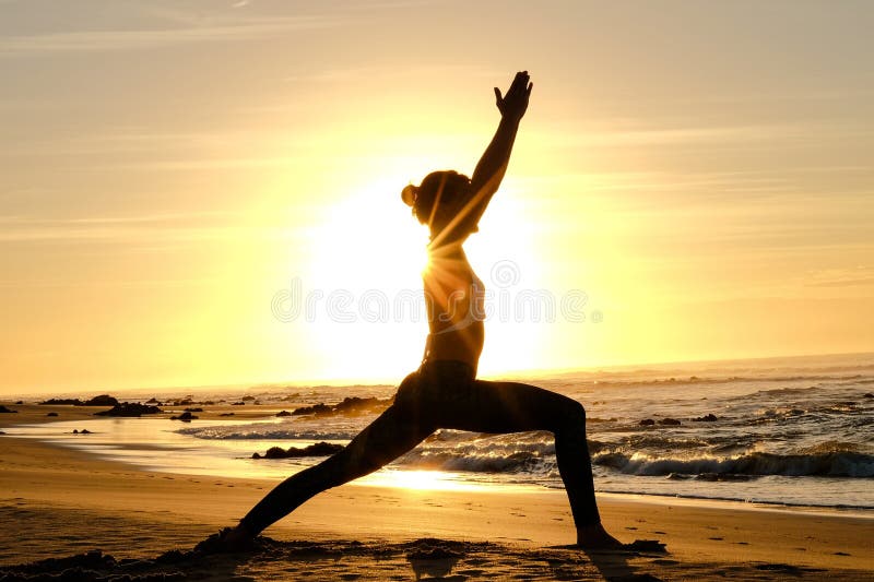 Bright sunrays behind yogi master forming silhouette stock photos