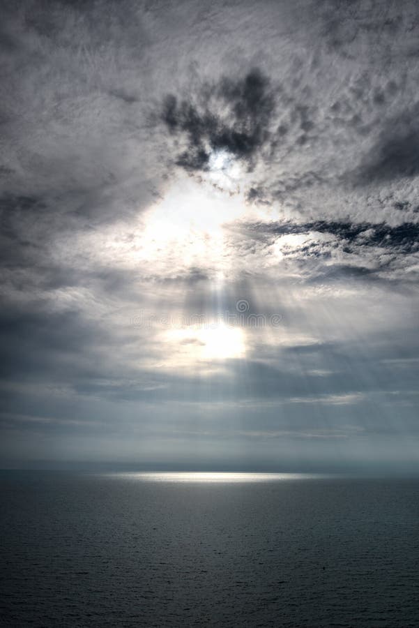 Bright Sunset In Blue Sky With Clouds Over Sea Ray Light Stock Photo