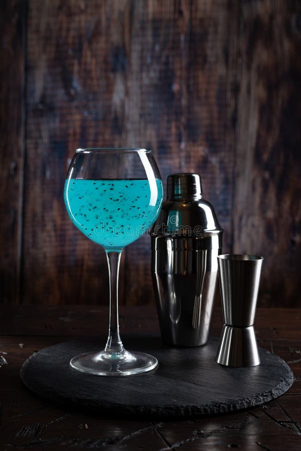 Bright Turquoise Cocktail and Shaker. Cocktail on the Bar. Shaker and