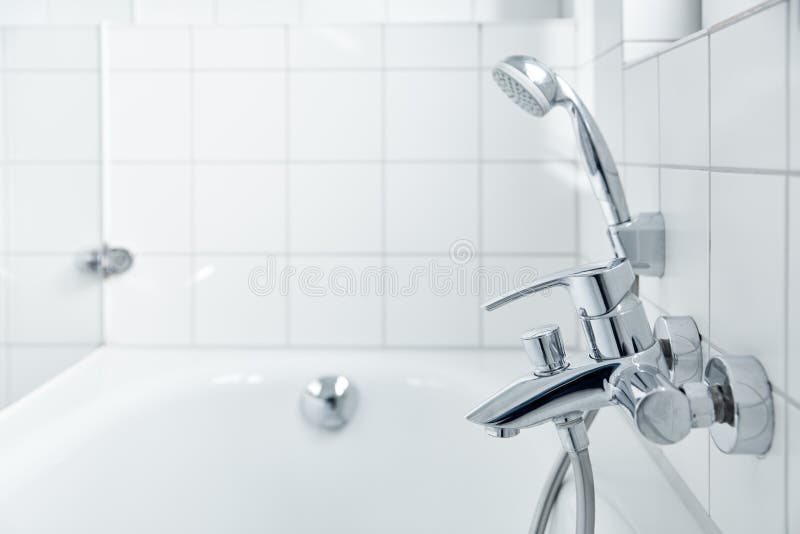 Bright white bathtub with shower head in modern bathroom royalty free stock image Bright white bathtub with shower head in modern bathroom royalty free stock image