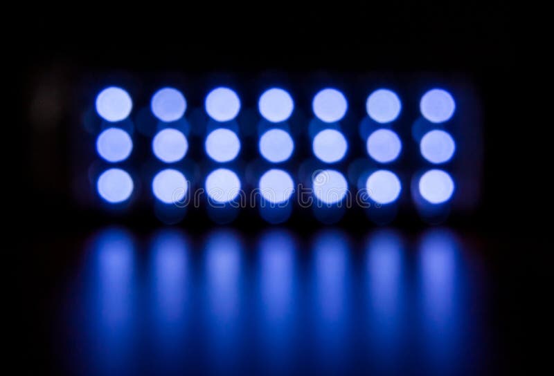 Bright White Fuzzy Lights Glow and Shine on a Dark Background_ Stock