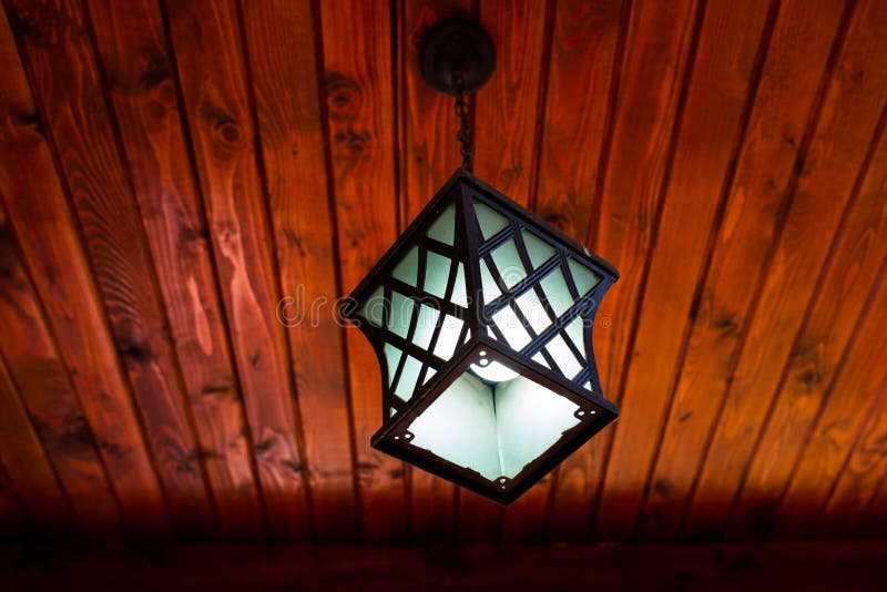 Bright white light bulb in the outdoor patio lamp at night