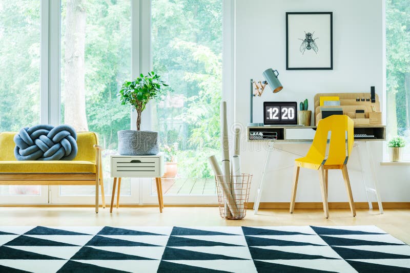 Bright workspace with yellow chair stock photos