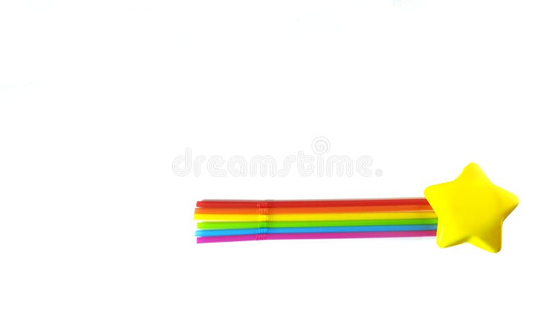 A bright yellow star and seven straws of rainbow colors lie on a white background. Objects depict a comet. The colors