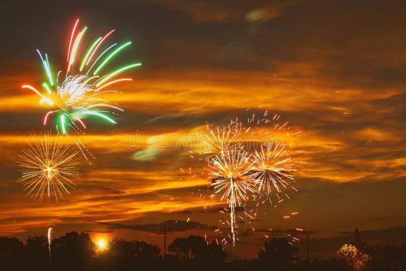 Brightly colorful fireworks in the sunset sky royalty free stock photography Brightly colorful fireworks in the sunset sky royalty free stock photography