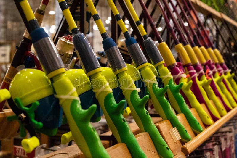 https://thumbs.dreamstime.com/b/brightly-coloured-youth-fishing-poles-displayed-sale-world-renowned-outdoor-sporting-goods-retailer-bright-colors-blue-142330529.jpg