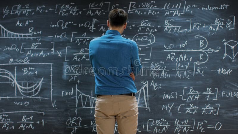 Brilliant Young Mathematician Approaches Big Blackboard and Thinks about Solving Long and Complex stock image