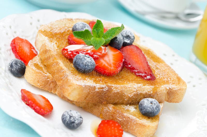 Crispy toast with honey, fresh berries, cup of coffee and orange juice for breakfast, close-up. Crispy toast with honey, fresh berries, cup of coffee and orange juice for breakfast, close-up