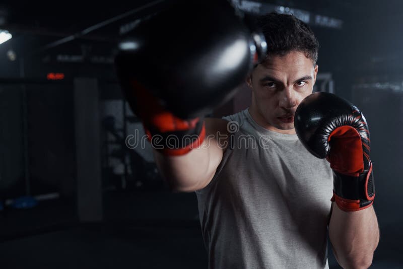 Bring it. Portrait of a Young Man Practicing His Boxing Routine at a