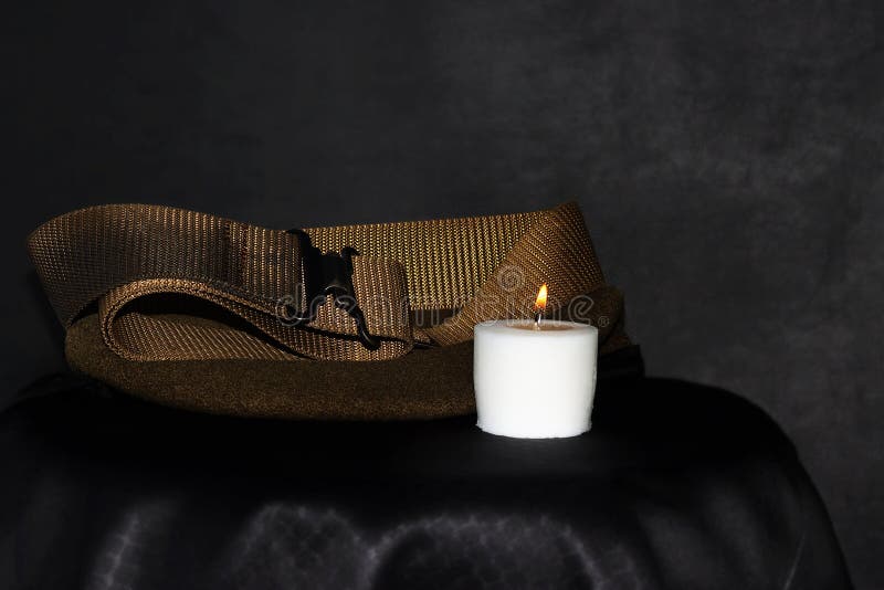 Burning Candle, Old Army IDF Belt and an Israeli Soldier`s Beret. Israel Memorial Day, Memorial Day for Fallen Soldiers and Victims of Hostile Acts, concept. Burning Candle, Old Army IDF Belt and an Israeli Soldier`s Beret. Israel Memorial Day, Memorial Day for Fallen Soldiers and Victims of Hostile Acts, concept