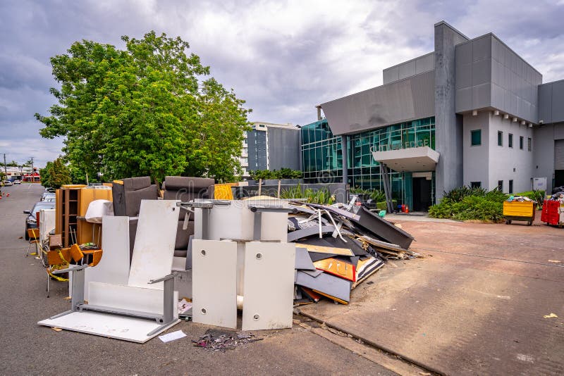 Brisbane, Queensland, Australia - Mar 4, 2022: Flood damaged office furniture dumped on the side of the road for collection