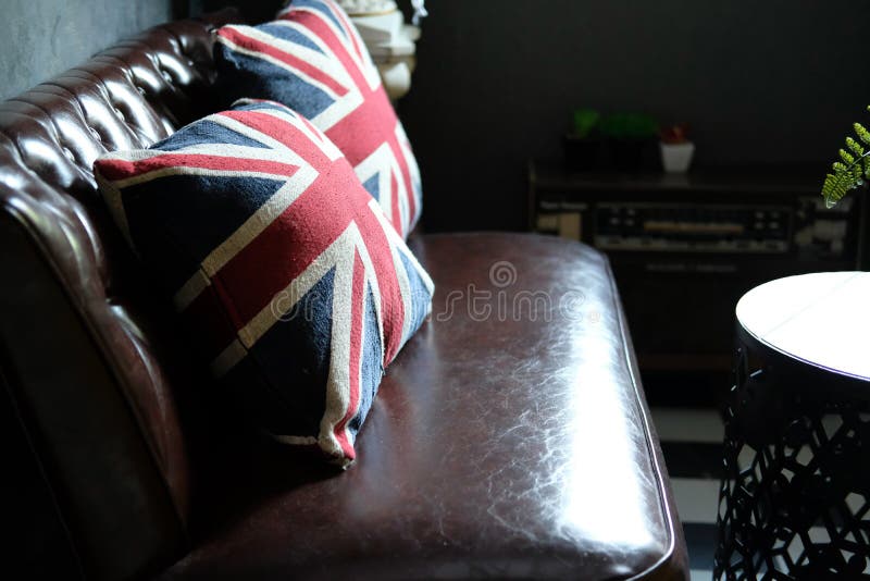 British Flag Pillow on Leather Sofa Couch in Living Room Interior Stock