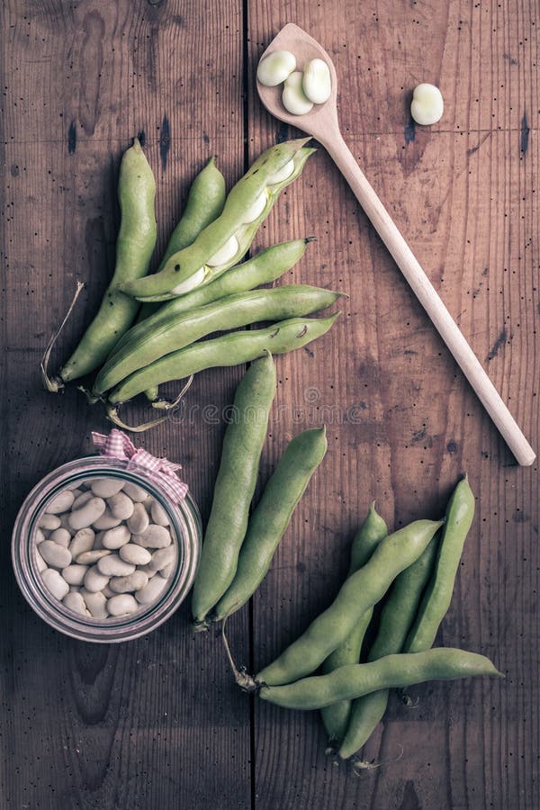 Broad Beans on a Wooden Table with Jar, Full of Dry Beans Stock Photo