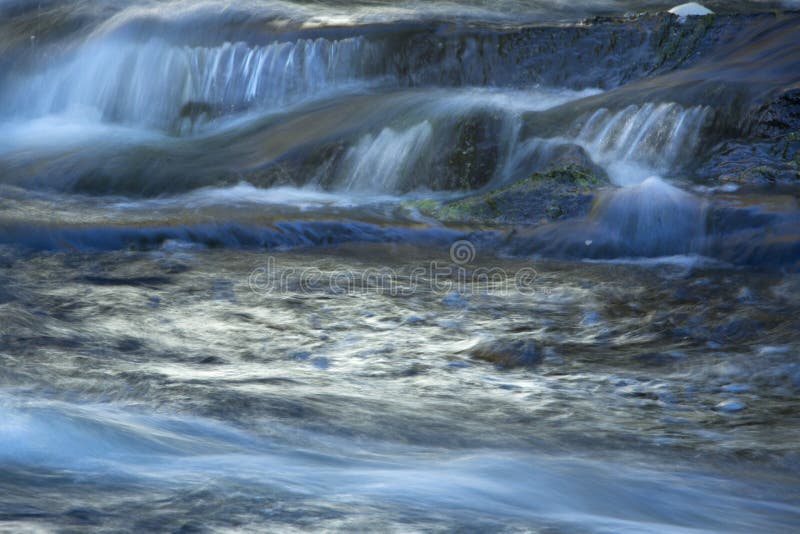 Broad Brook cascades over a waterfall in East Windsor, Connecticut. Silky, cascading water of Broad Brook waterfall in East Windsor, Connecticut, in springtime royalty free stock image Broad Brook cascades over a waterfall in East Windsor, Connecticut. Silky, cascading water of Broad Brook waterfall in East Windsor, Connecticut, in springtime royalty free stock image