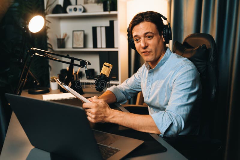Broadcaster reading script note to listener in warm light at night. Pecuniary. royalty free stock image