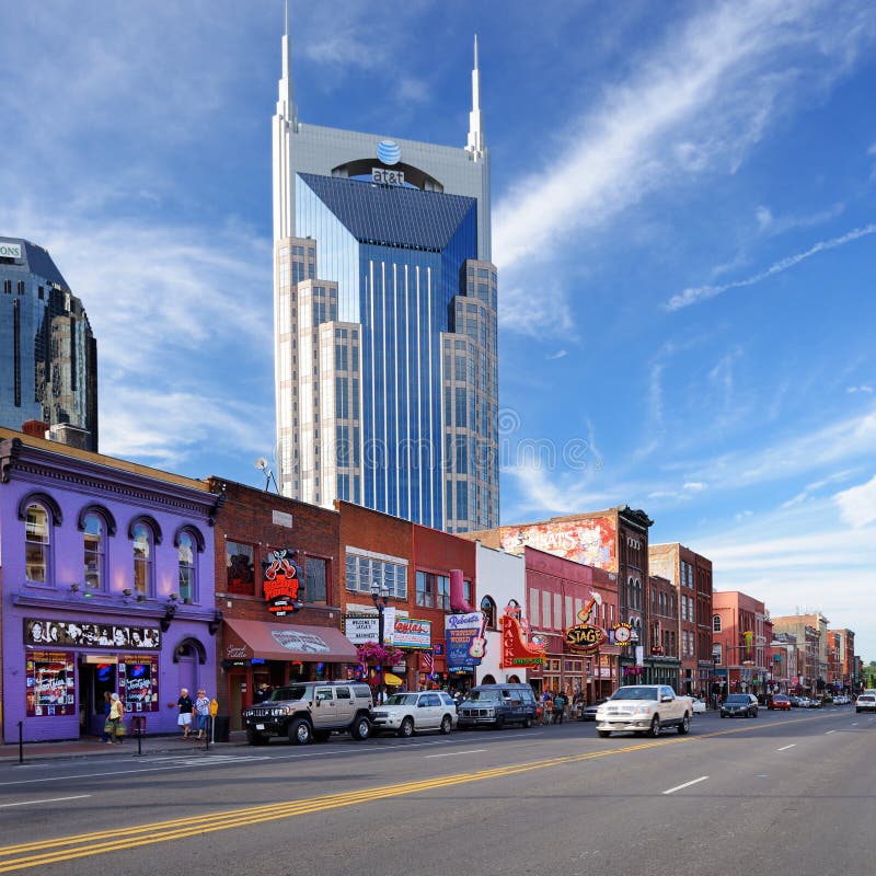 The At&t Building towers over Honky-tonks on Lower Broadway June 16, 2013 in Nashville, Tennessee. The district is famous for the numerous country music entertainment bars. The At&t Building towers over Honky-tonks on Lower Broadway June 16, 2013 in Nashville, Tennessee. The district is famous for the numerous country music entertainment bars.